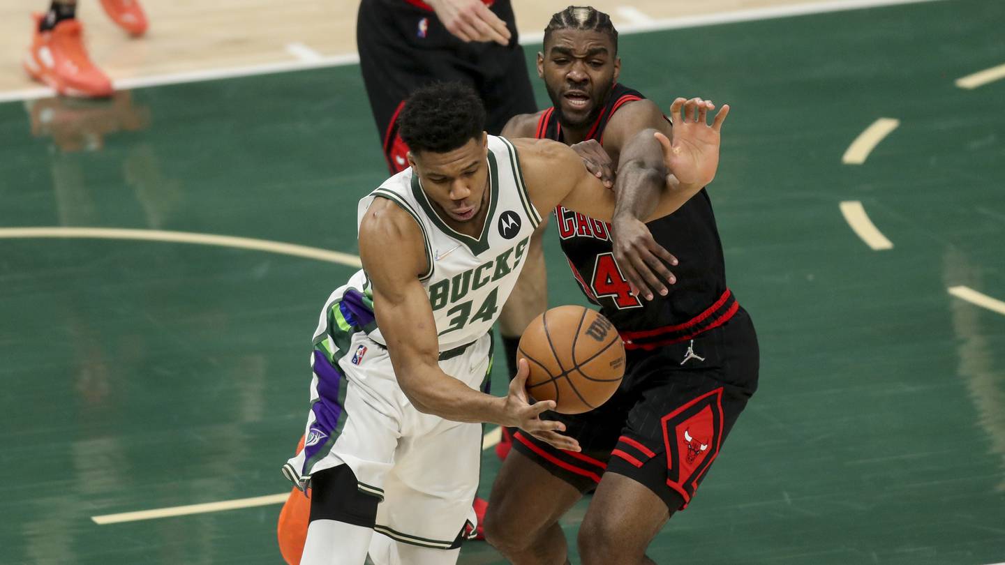 Bulls forward Patrick Williams, right, battles Bucks forward Giannis Antetokounmpo during the first half of Game 1 of the Eastern Conference playoffs on April 17, 2022, at Fiserv Forum in Milwaukee. 