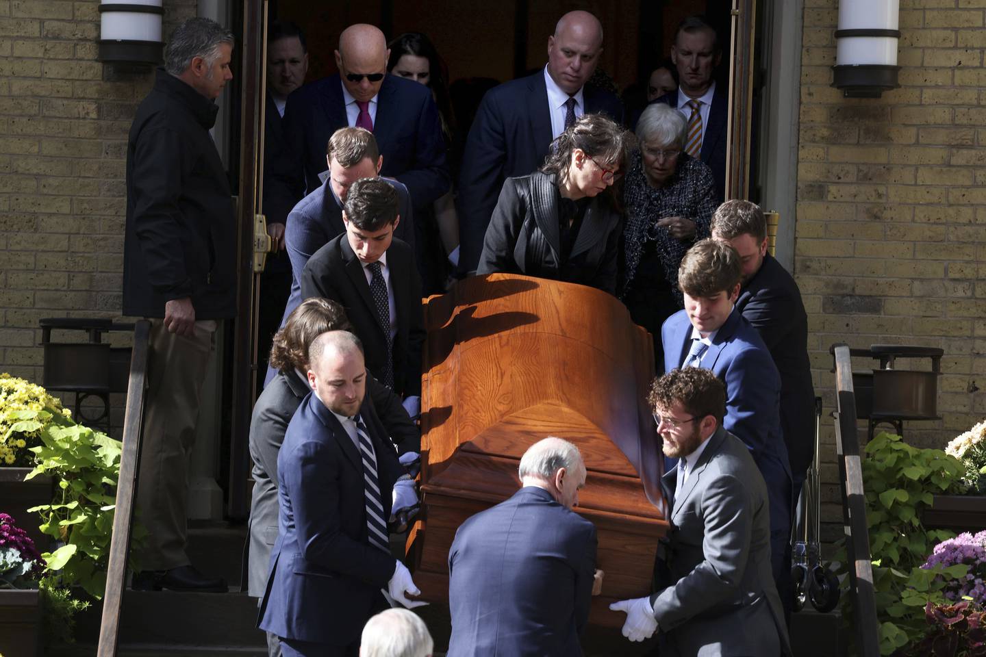 Pallbearers carry the casket of former Bears general manager Jerry Vainisi following his funeral at Old St. Patrick’s Church in Chicago on Oct. 14, 2022.  