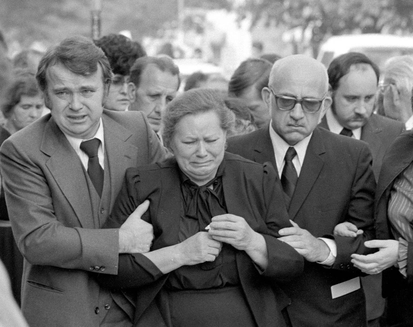 Alojza and Tadeusz Janus, center and right, grieve outside St. Hyacinth Catholic Church in Chicago, which hosted the 1982 funeral for their sons Adam and Stanley and daughter-in-law Theresa. Their son Joseph is behind at right.