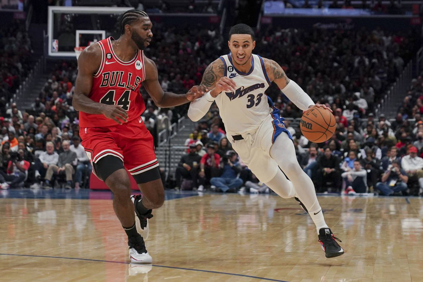 Wizards forward Kyle Kuzma, right, drives against Bulls forward Patrick Williams during the second half Friday in Washington. 
