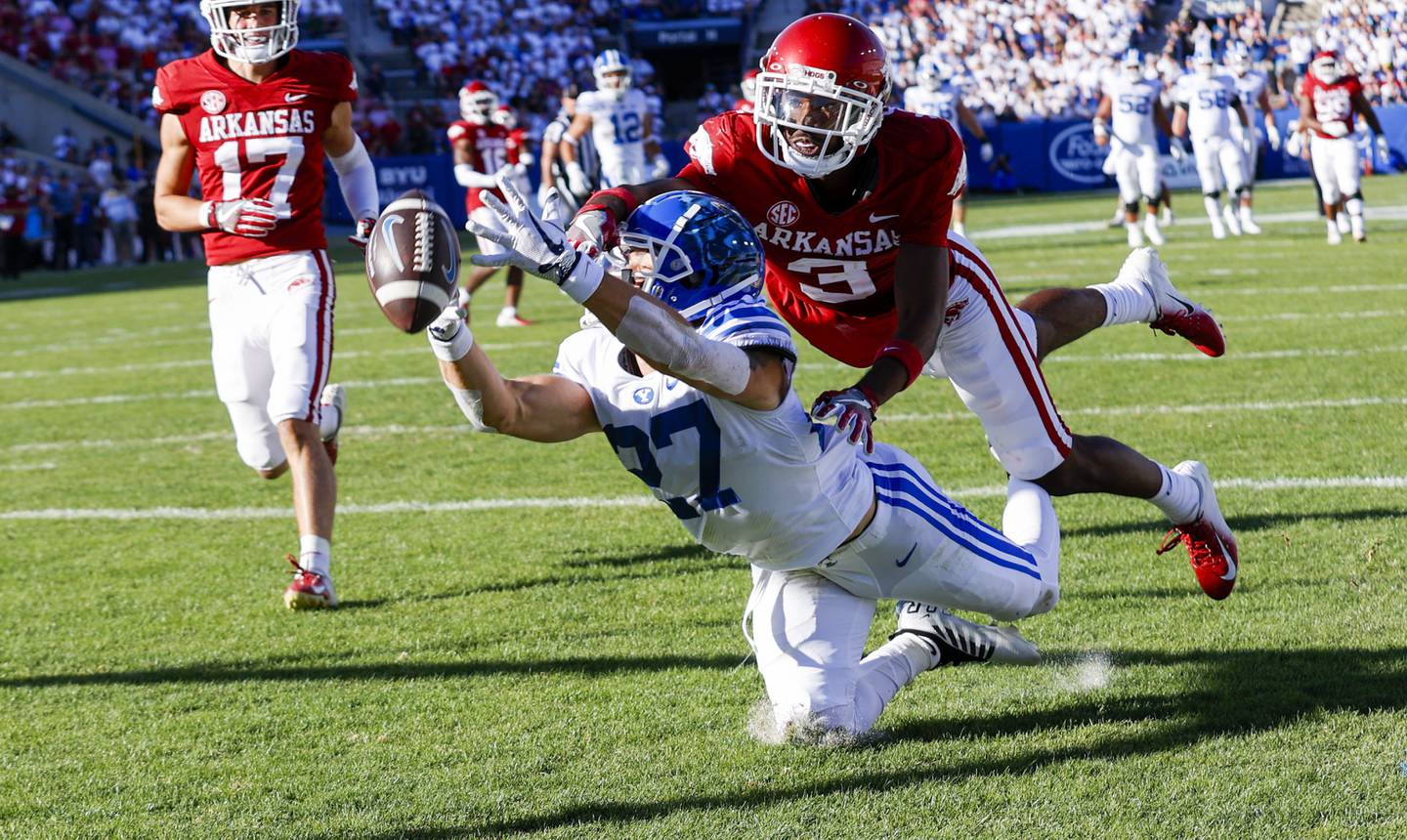 BYU wide receiver Chase Robberts (27) drops a pass while defended by Arkansas' Dwight McGlothern (3) during a game in Provo, Utah, on Saturday,