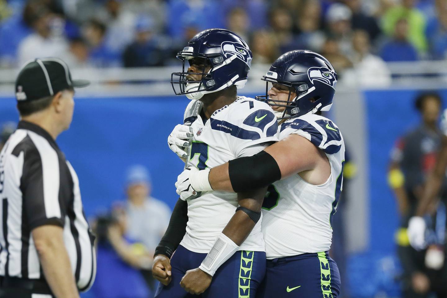 Seahawks quarterback Geno Smith is hugged by guard Austin Blythe, right, after Smith rushed for an 8-yard touchdown during the first half against the Lions on Sunday, Oct. 2, 2022, in Detroit.