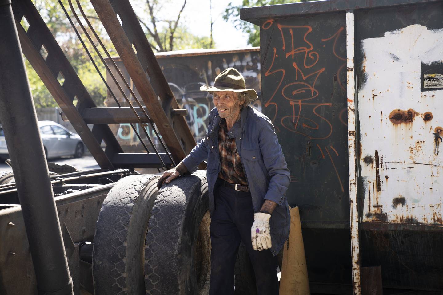 Ken Dunn works on a container filled with newsprint at his North Park Village Recycling Station drop-off site.