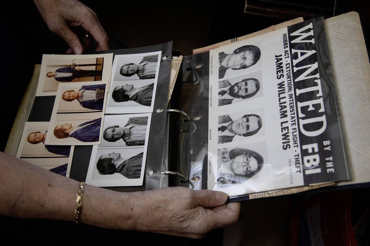 Retired FBI agent Tom Ellis holds an album featuring photos and newspaper clippings about the Tylenol case, including mug shots of James Lewis.
