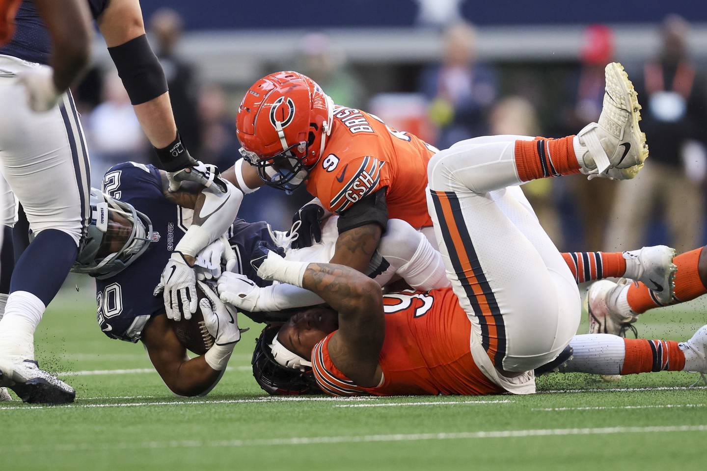 Bears linebacker Trevis Gipson loses his helmet while tackling Cowboys running back Tony Pollard during the second quarter at AT&T Stadium on Oct. 30, 2022.