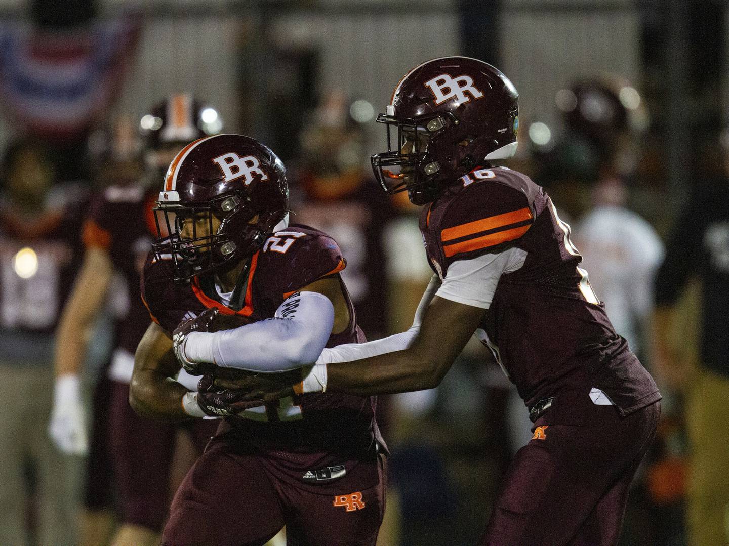 Brother Rice quarterback Marcus Brown (16) hands off the ball to Randall Nauden (21) during a CCL/ESCC Blue game in Chicago on Friday, Sept. 30, 2022.