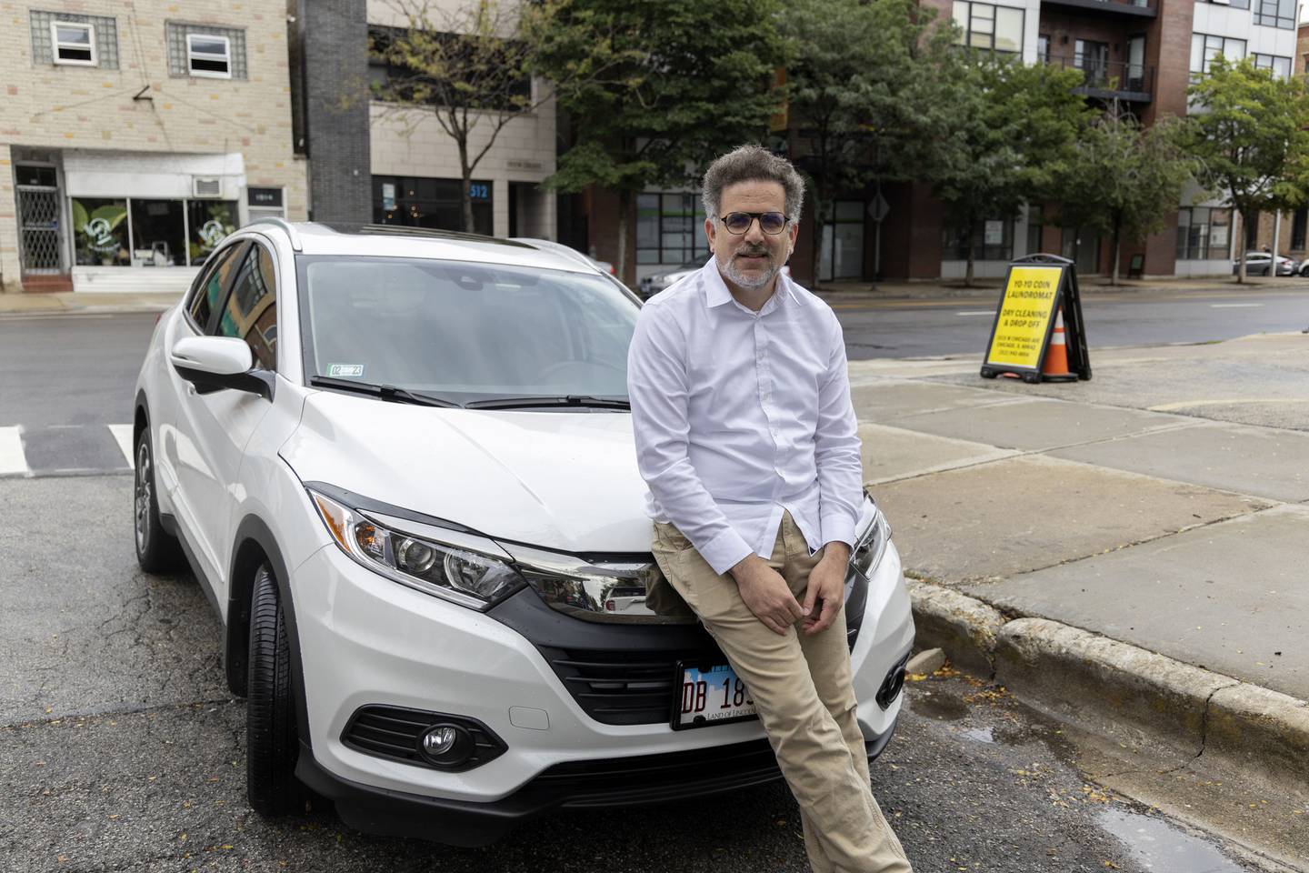 Seth Blumenthal checks out a building for lease in Chicago on Aug. 8, 2022. Blumenthal was once carless in Chicago and loved using public transit, but caved and bought a car during the pandemic when CTA service declined.  