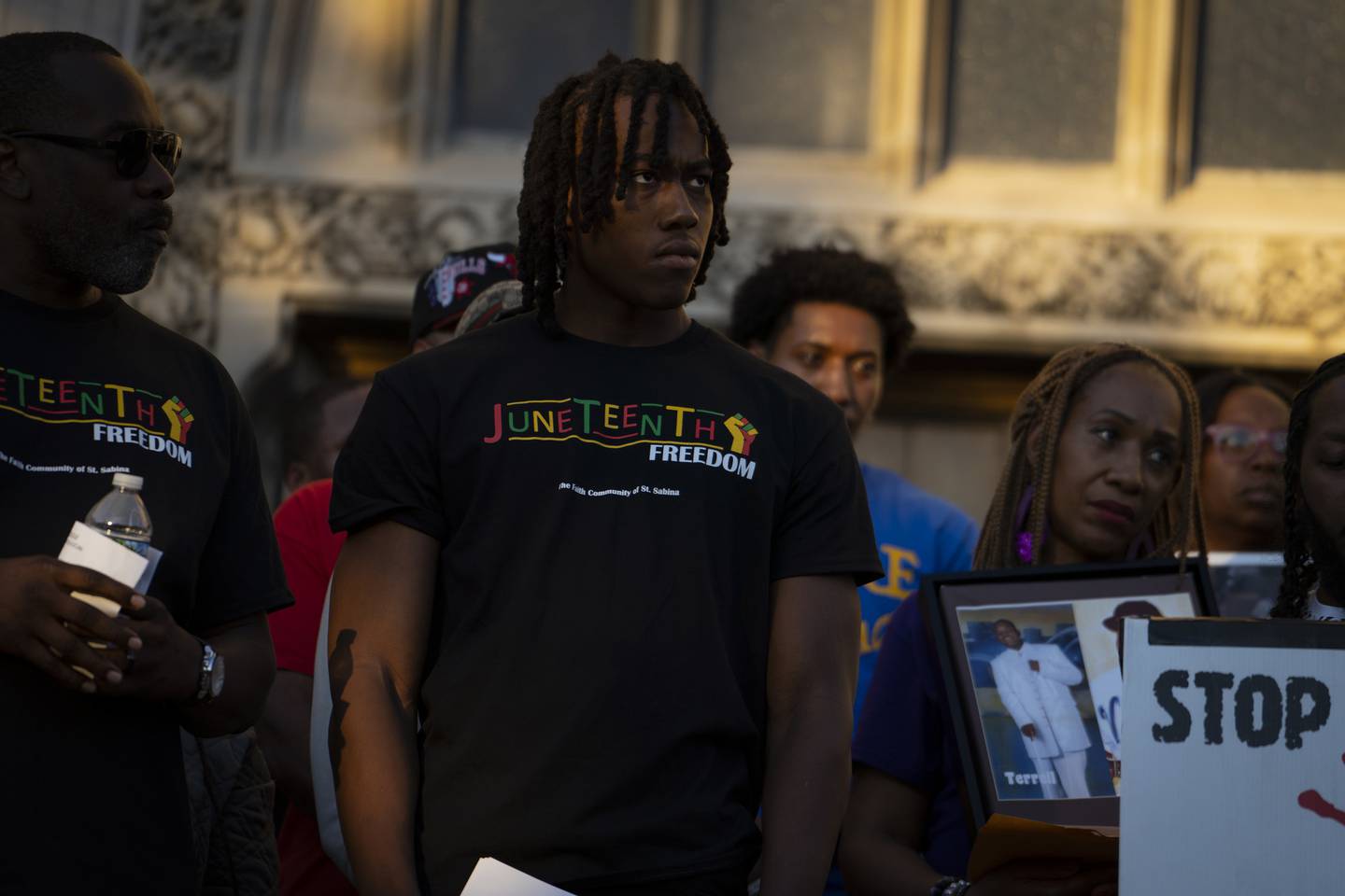 Bulls guard Ayo Dosunmu listens on the steps of St. Sabina Catholic Church before his remarks at “The Call for Peace Rally and March” on June 17, 2022, in Chicago.  