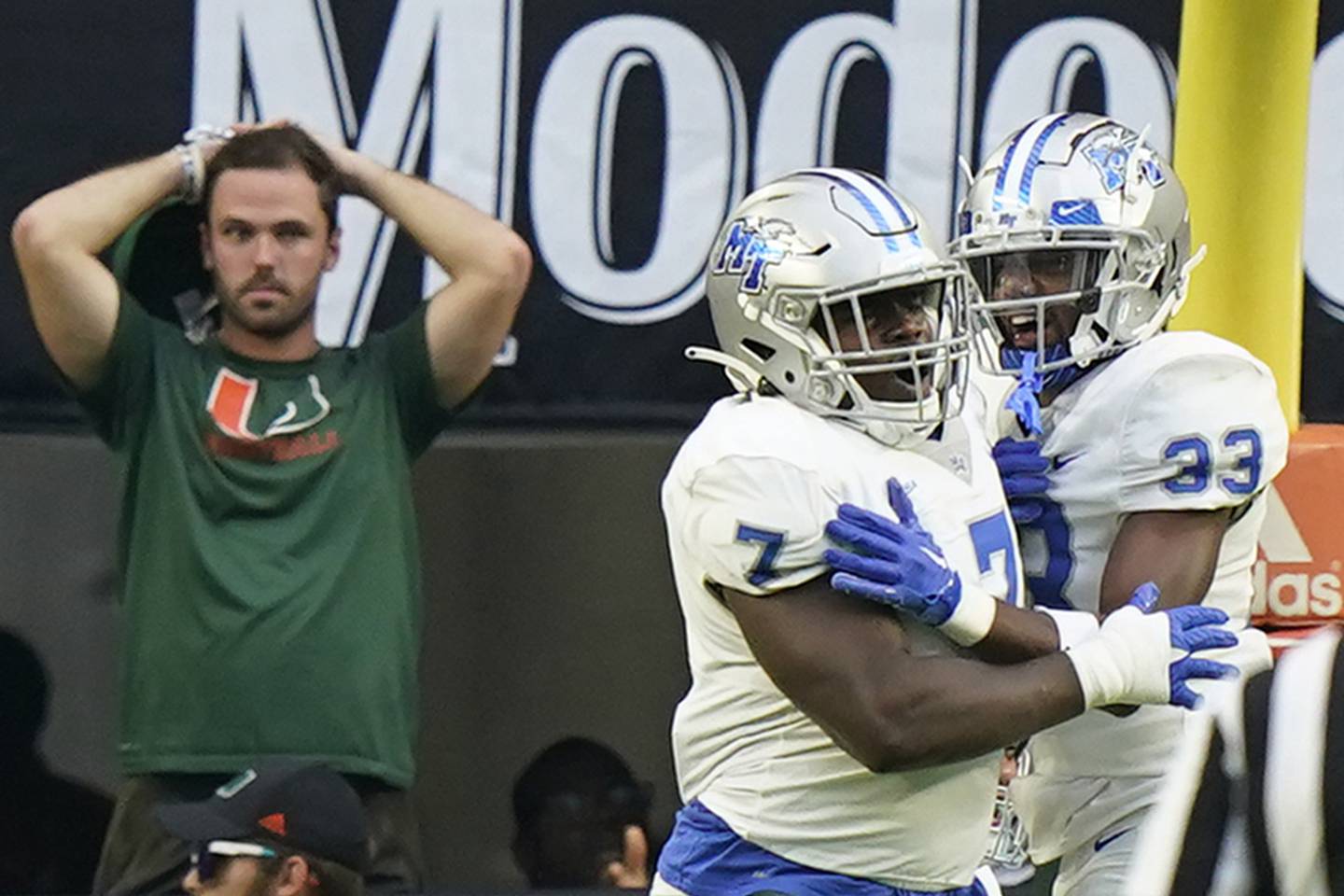 Middle Tennessee defensive tackle Zaylin Wood (7) celebrates with cornerback Decorian Patterson (33) after Wood scored on an interception return against Miami on Sept. 24, 2022, in Miami Gardens, Fla.