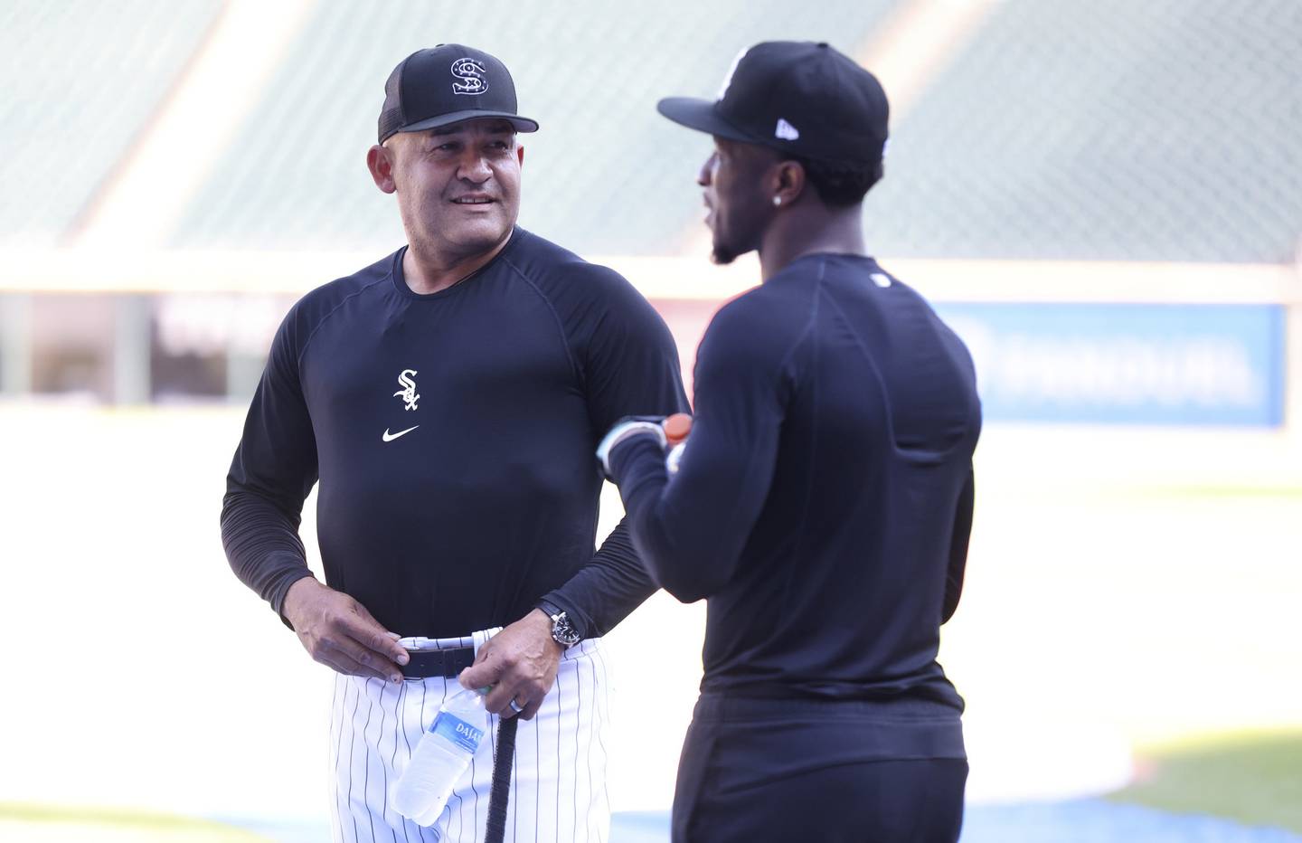 Acting White Sox manager Miguel Cairo talks with injured Tim Anderson during batting practice at Guaranteed Rate Field on Aug. 31, 2022.