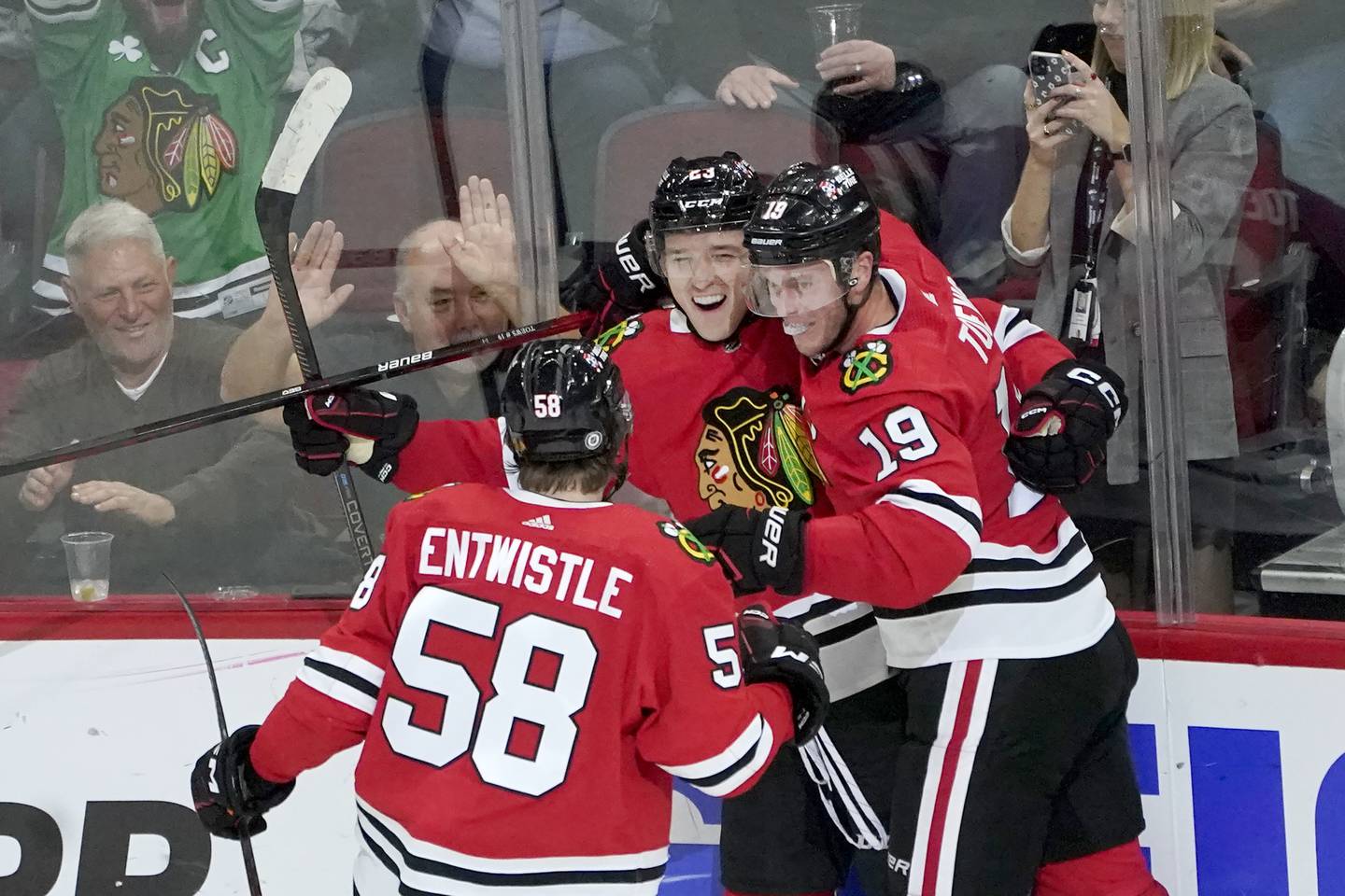 Philipp Kurashev, center, celebrates his goal with Jonathan Toews (19) and MacKenzie Entwistle during the second period against the Panthers on Tuesday at the United Center. 