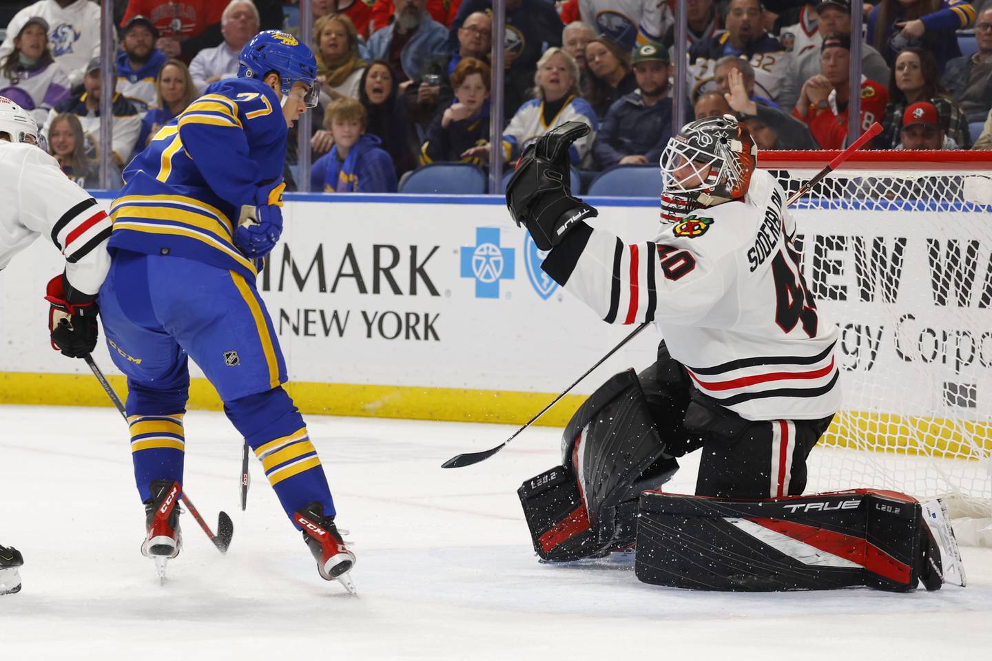 Blackhawks goaltender Arvid Söderblom makes a glove save on Sabres right wing JJ Peterka during the first period Saturday in Buffalo, N.Y. 