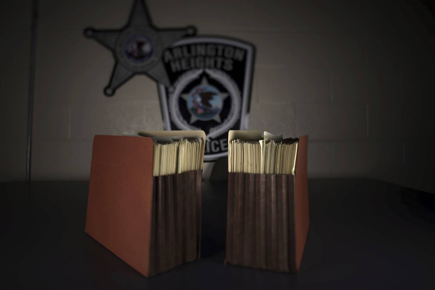 Two accordion-style folders containing Tylenol documents sit on a table at the Arlington Heights Police Department on Sept. 19, 2022. 