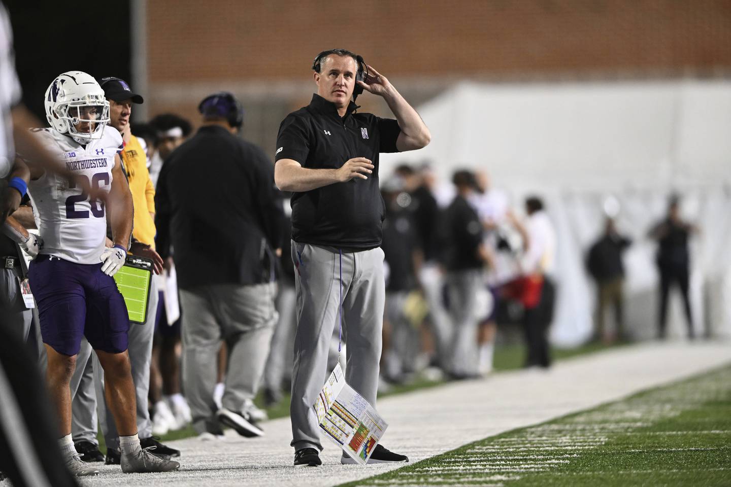 Northwestern coach Patt Fitzgerald looks on from the sideline in the second half against Maryland on Saturday in College Park, Md. The Wildcats lost 31-24. 