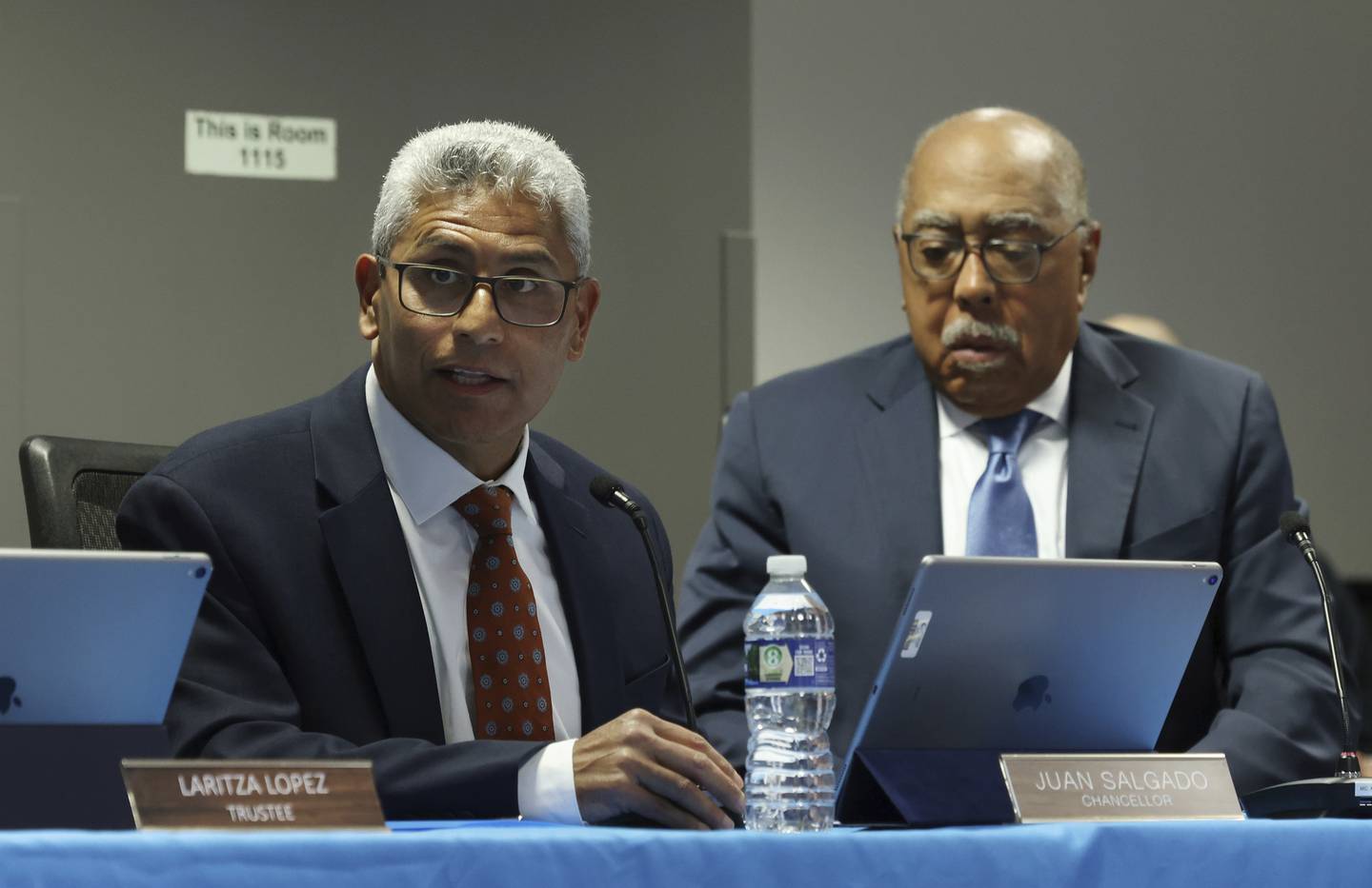City Colleges of Chicago Chancellor Juan Salgado, left, addresses attendees at a board meeting as Chairperson Walter Massey, right, listens at Harold Washington College in Chicago on Oct. 6, 2022. 