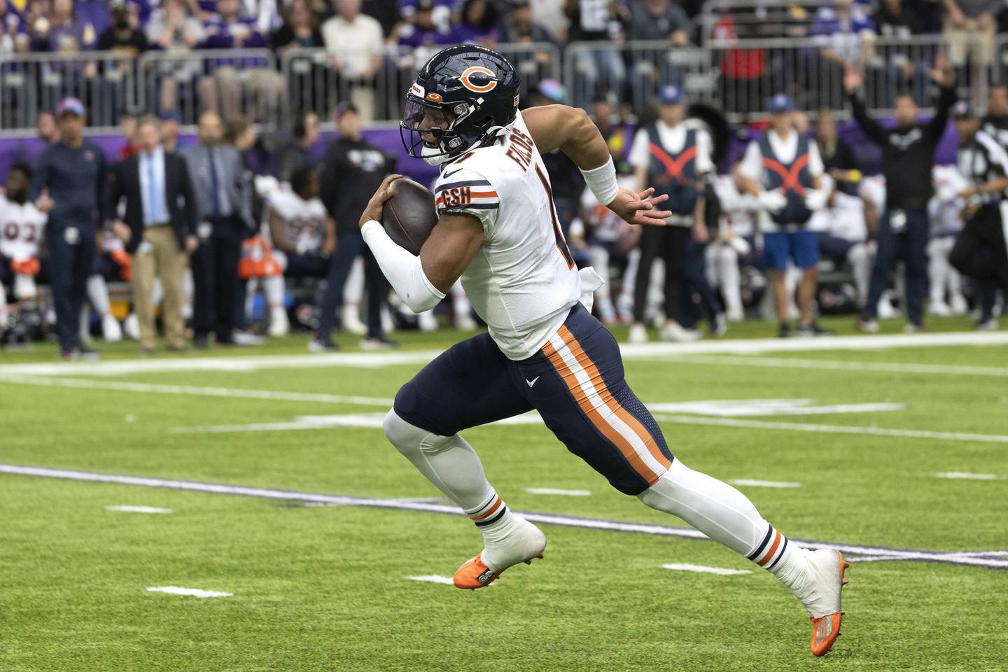 Bears quarterback Justin Fields runs the field on his way to what would be a nullified touchdown after an illegal block by wide receiver Ihmir Smith-Marsette during the fourth quarter against the Vikings at U.S Bank Stadium on Oct. 9, 2022.