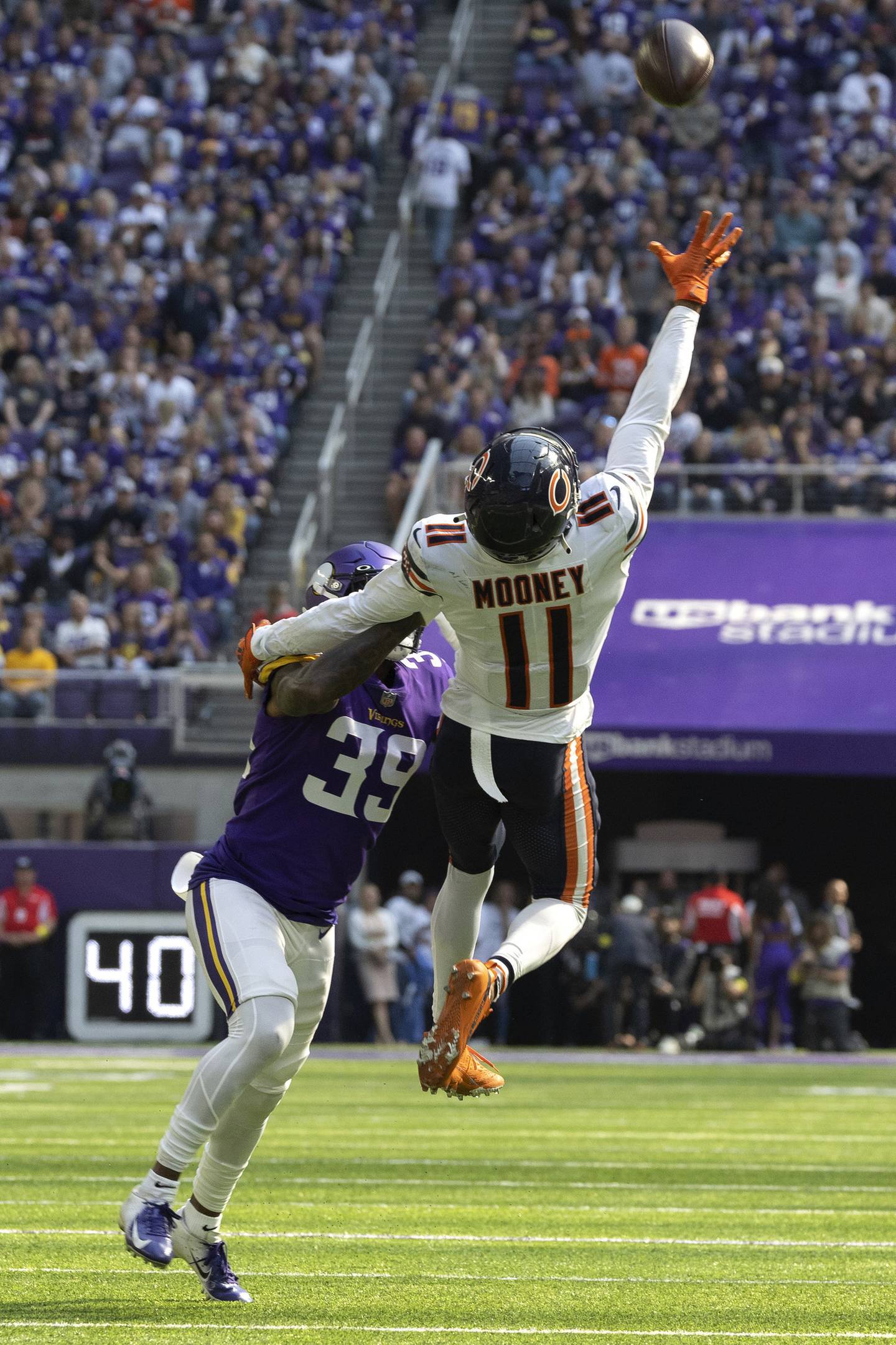 Bears wide receiver Darnell Mooney makes a one-handed catch on top of Vikings cornerback Chandon Sullivan during the second quarter at U.S. Bank Stadium on Oct. 9, 2022.