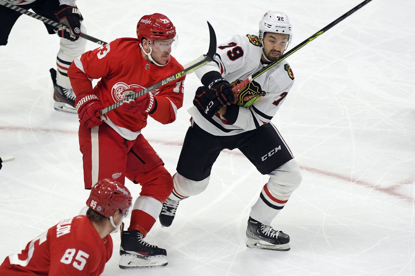 The Red Wings' Adam Erne, left, and Blackhawks' Dylan Sikura battle for position during a preseason game on Sept. 28, 2022, in Detroit. 