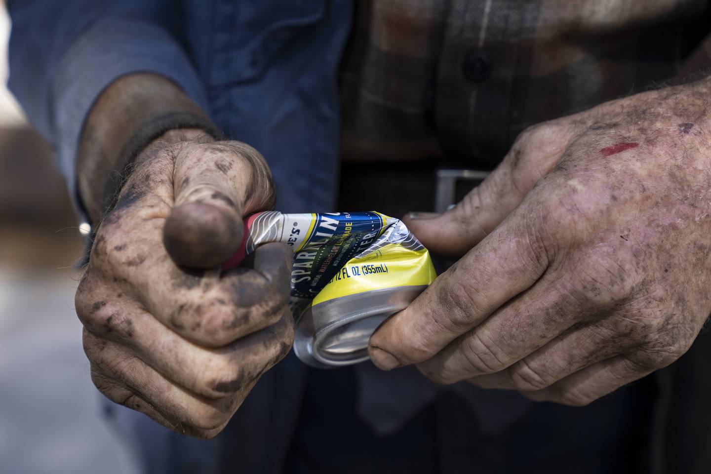 Ken Dunn crushes an aluminum can at his North Park Village Recycling Station drop-off site on Sept. 27, 2022. 