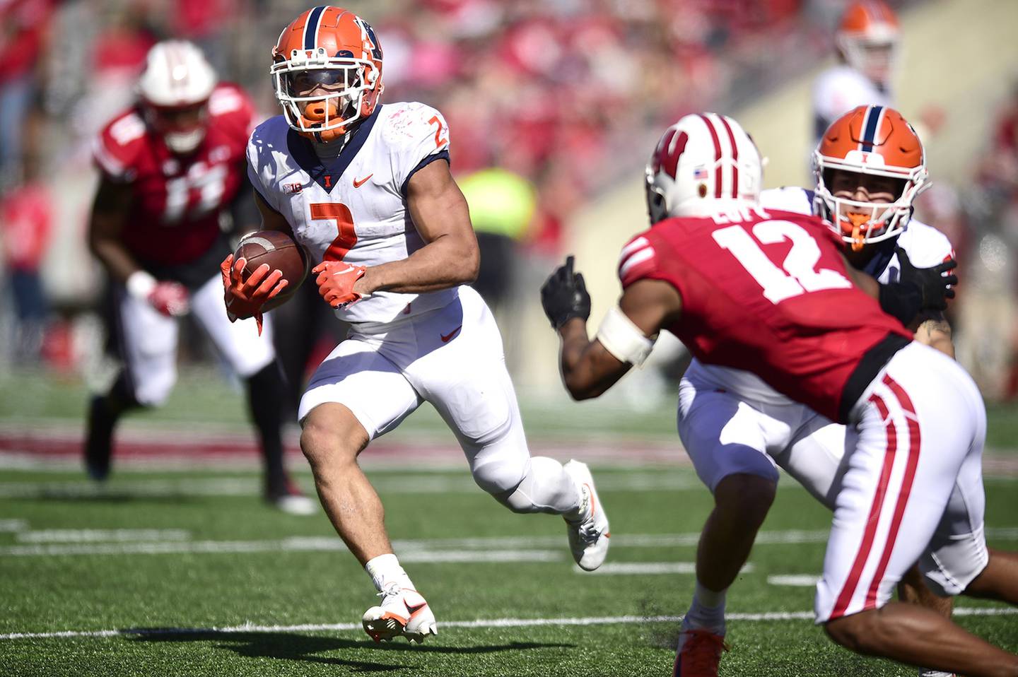 Illinois' Chase Brown (2) looks for running room against Wisconsin on Saturday in Madison, Wis. Brown rushed for 129 yards and a touchdown in the Illini's 34-10 victory. 