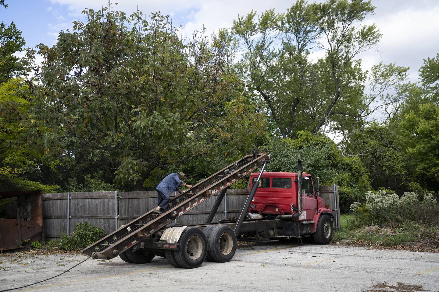 Ken Dunn works on a truck at his North Park Village Recycling Station drop-off site.
