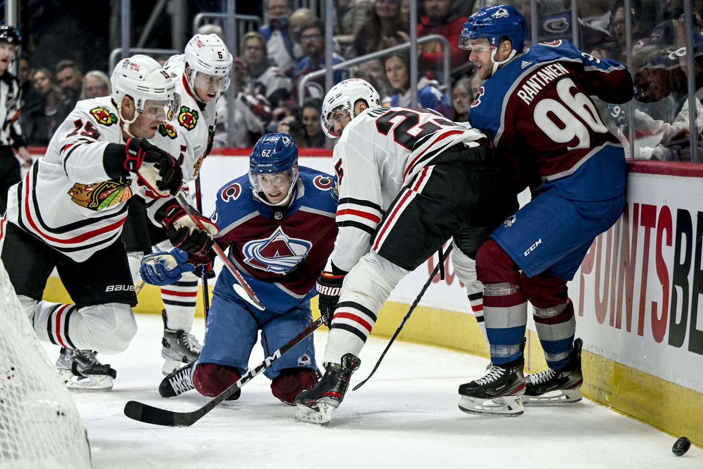 The Avalanche's Artturi Lehkonen is trapped by Jarred Tinordi, Connor Murphy and Jonathan Toews during the first period on Oct. 12, 2022. 