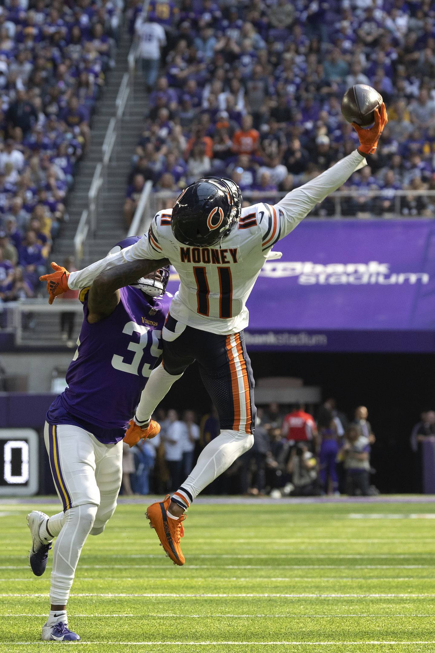 Bears wide receiver Darnell Mooney makes a one-handed catch away from Vikings cornerback Chandon Sullivan during the second quarter on Oct. 9, 2022.