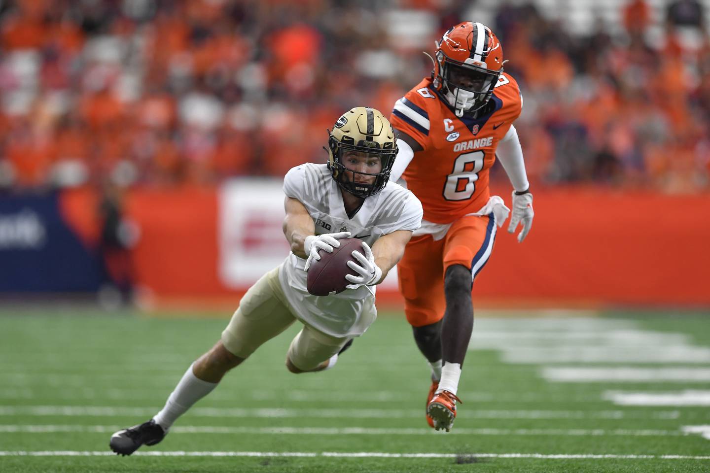 Purdue wide receiver Charlie Jones reaches for a pass while defended by Syracuse defensive back Garrett Williams on Sept. 17, 2022, in Syracuse, N.Y.