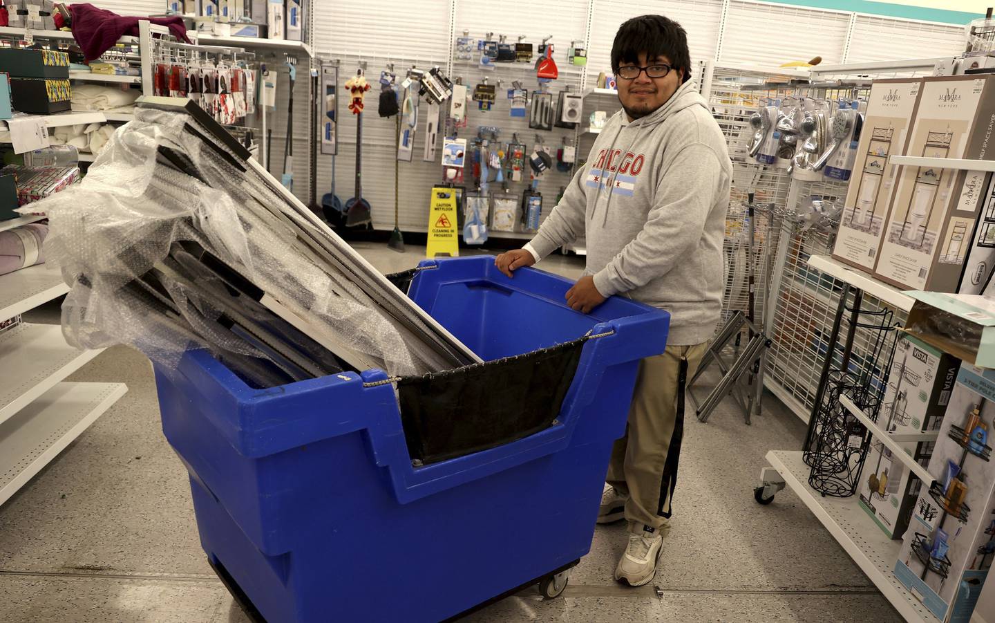 Alejandro Sanchez wheels several wall mirrors to shelves at his job at dd’s Discounts store in Cicero on Oct. 3, 2022  