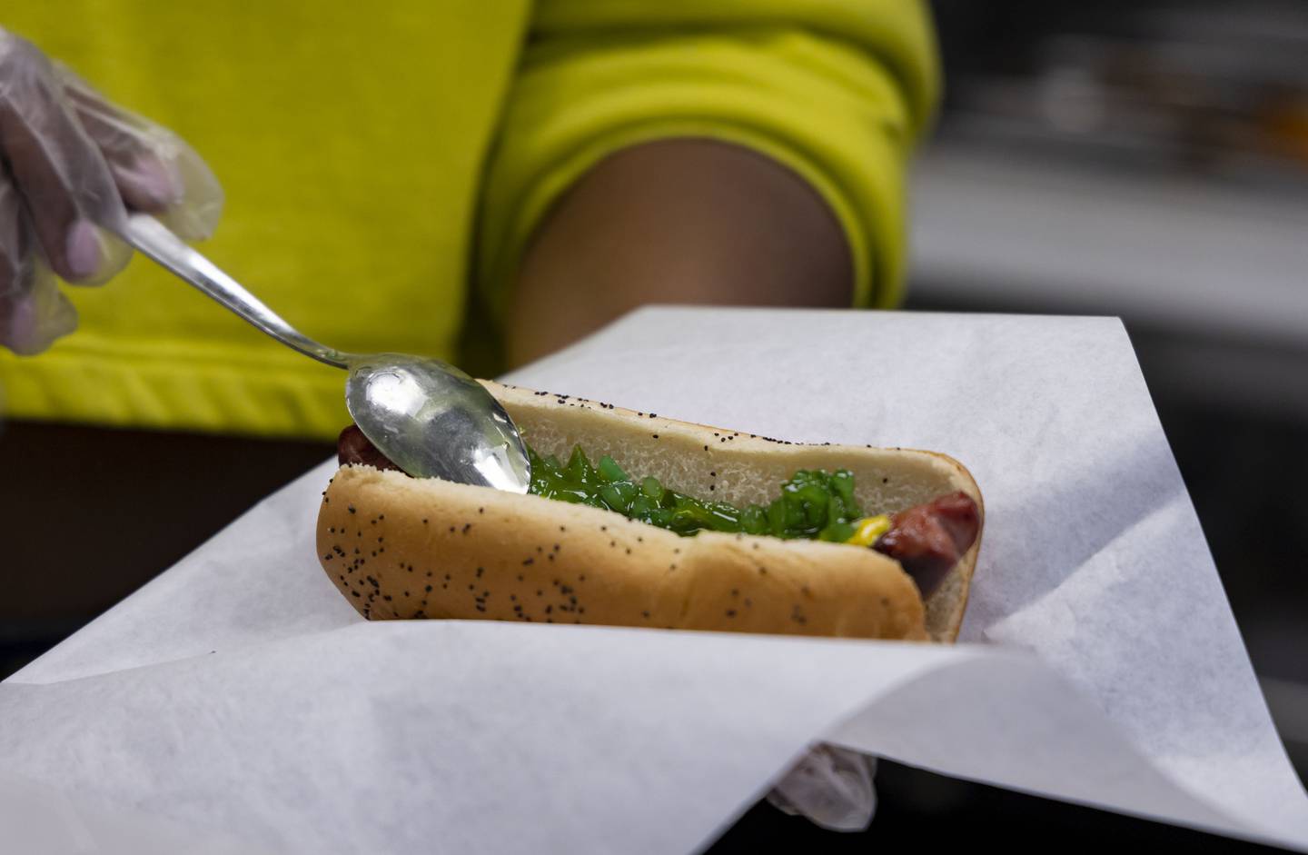 The Wiener's Circle char dog is prepared with green relish and other ingredients.