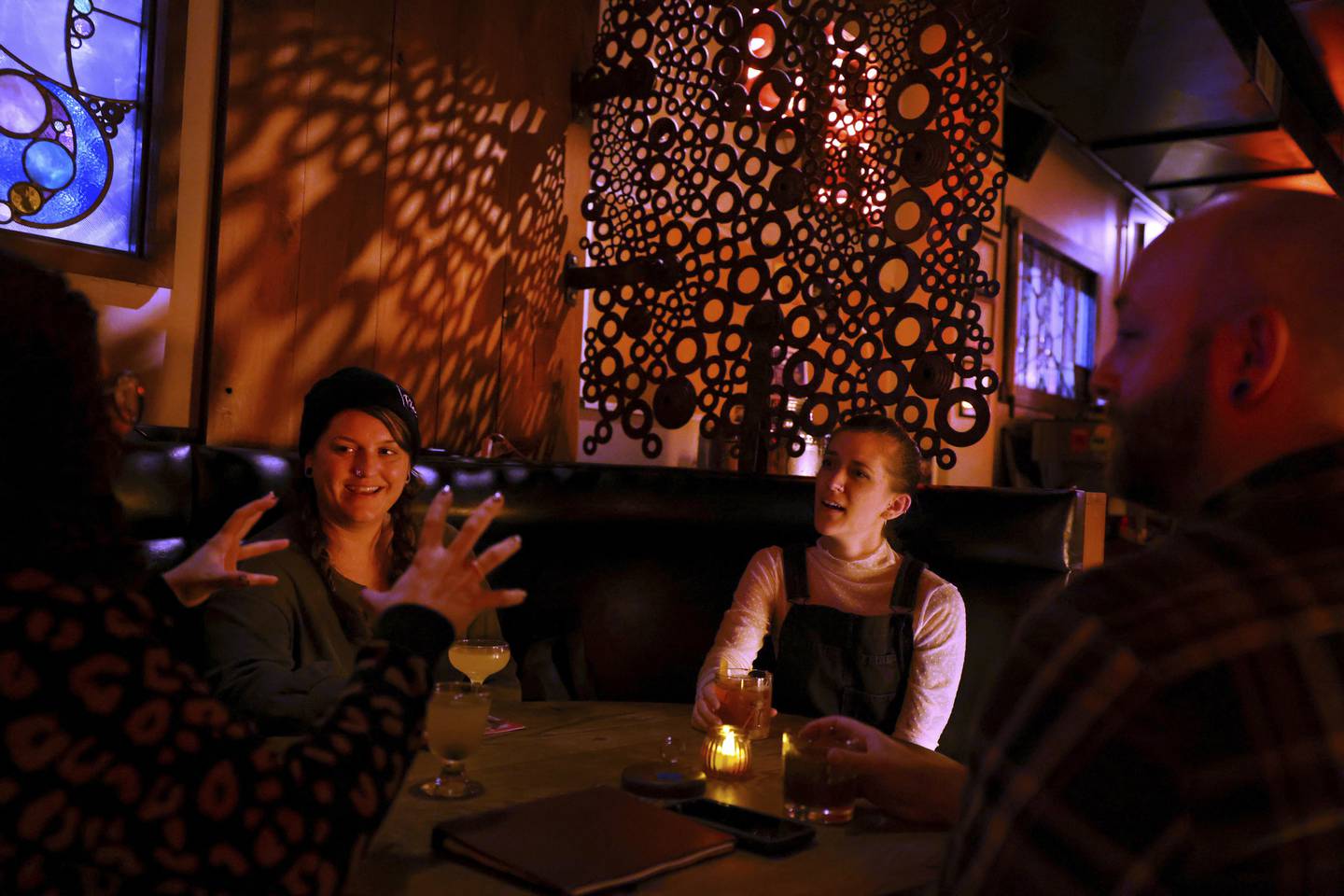 Jen Scarlato, center left, and Kayla Klammer, center right, hang out with friends at the Long Room on Irving Park Road at Ashland Avenue in Chicago on Oct. 6, 2022.  