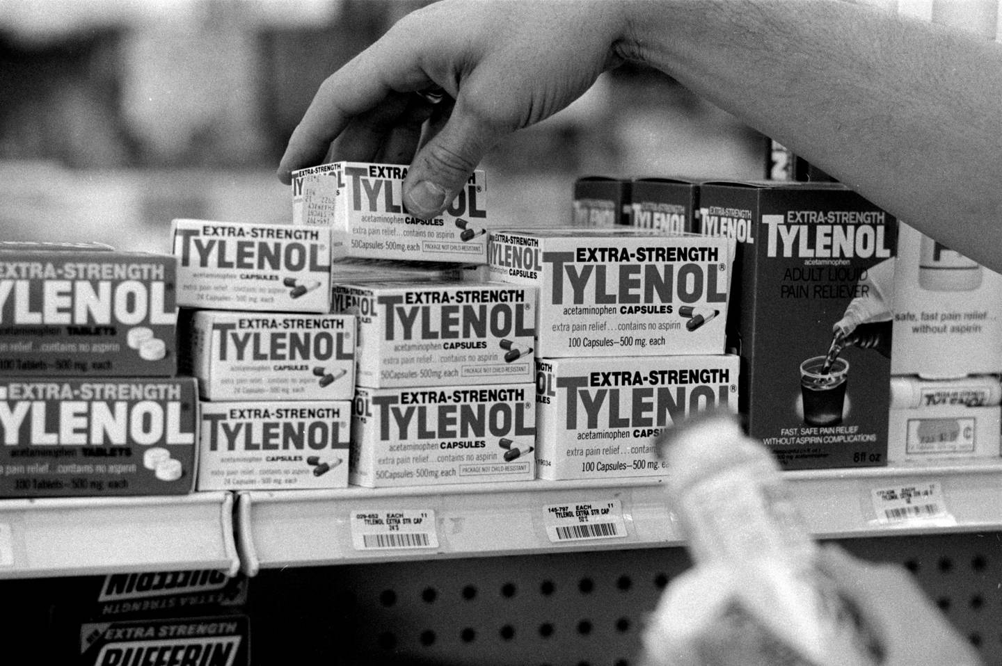 A pharmacist checks lot codes on boxes of Extra-Strength Tylenol. The initial recalls were limited to certain batches of the product.