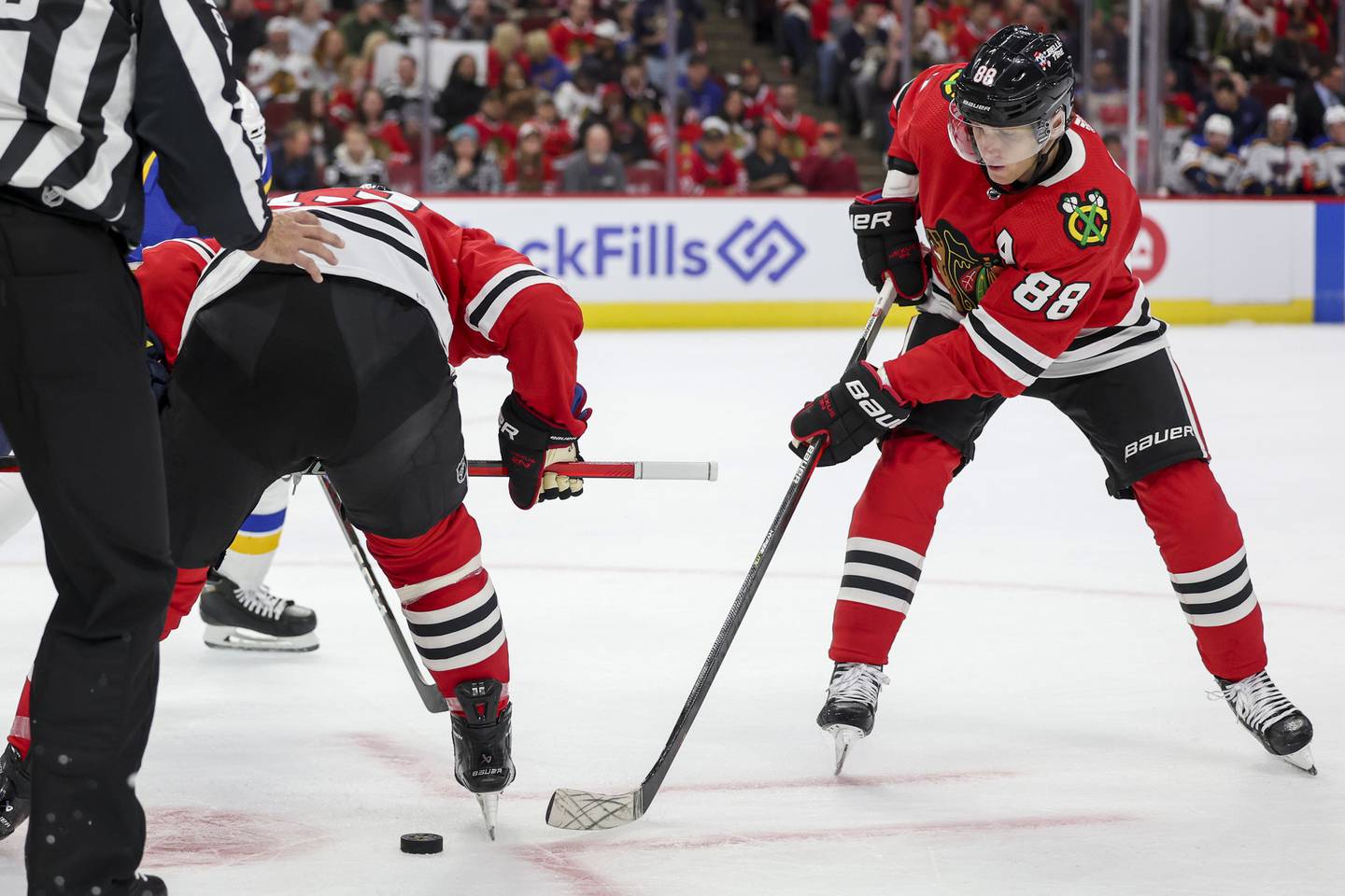 Blackhawks center Max Domi, left, and right wing Patrick Kane (88) try to gain possession of the puck during a preseason game against the Blues on Sept. 27, 2022, at the United Center.