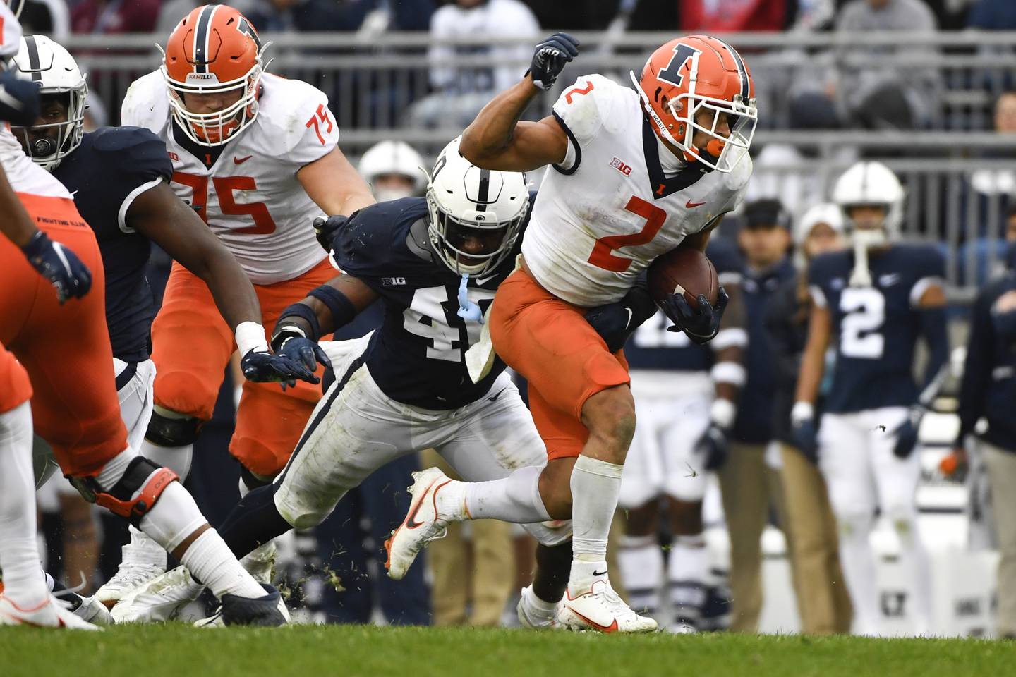 Illinois running back Chase Brown (2) sprints past Penn State linebacker Jesse Luketa on Oct. 23, 2021, in State College, Pa. 