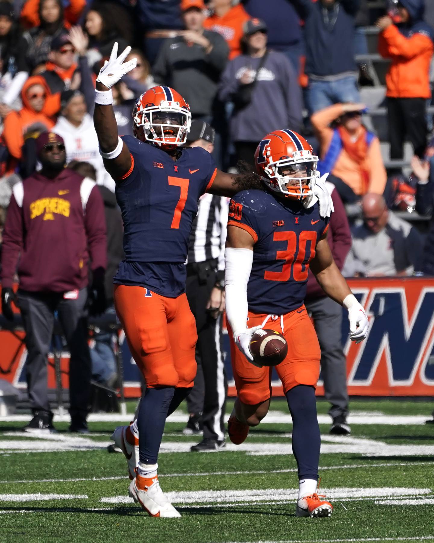 Illinois' Kendall Smith (7) celebrates with teammate Sydney Brown after Brown's interception against Minnesota during the second half on Oct. 15, 2022, in Champaign. 