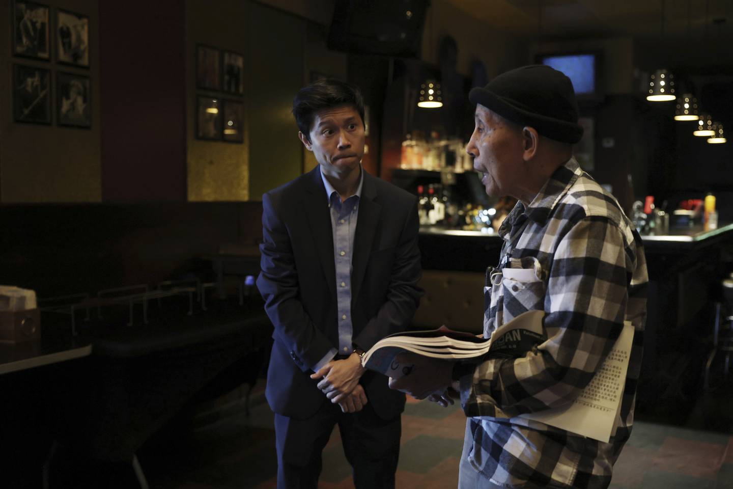 Hoan Huynh, left, the Democratic candidate for Illinois House District 13, listens to prospective voter Tai Nham Chung, 93, during a campaign event on Sept. 17 in Chicago. 