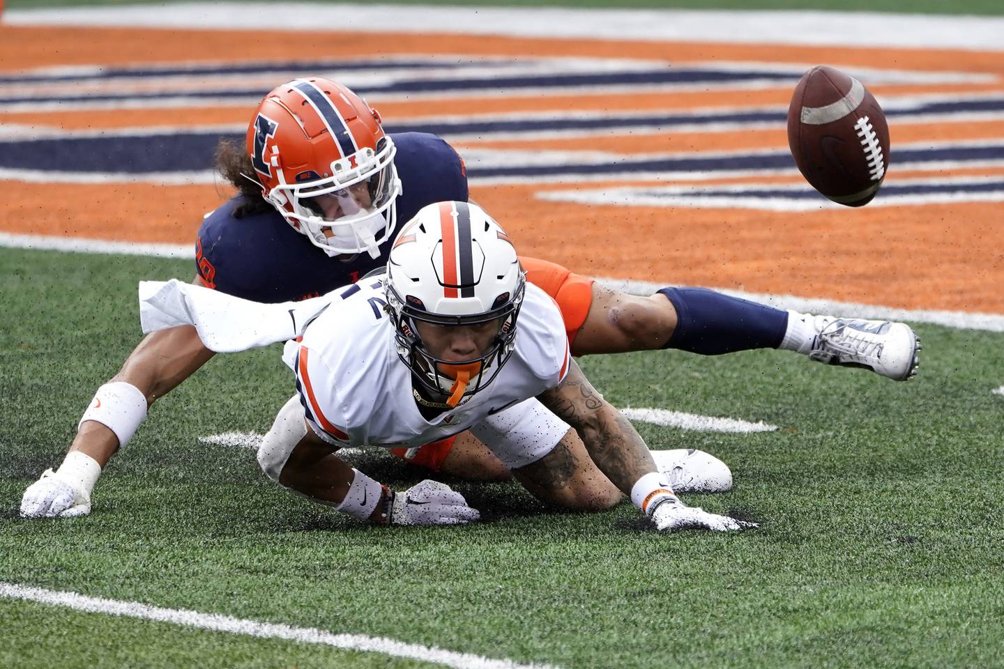 Illinois safety Sydney Brown, left, forces Virginia's Billy Kemp IV to fumble on a punt return on Sept. 10, 2022, in Champaign. Illinois recovered the fumble for a touchdown. 