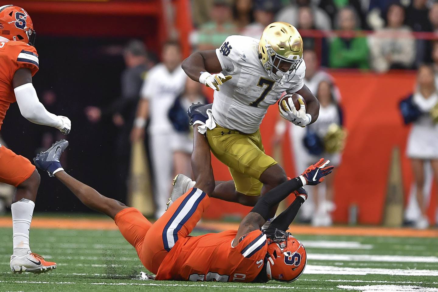 Notre Dame's Audric Estime (7) runs over Syracuse linebacker Alijah Clark during the first half Saturday in Syracuse, N.Y. Estime ran for 123 yards and two touchdowns on 20 carries in the Irish's 41-24 win. 