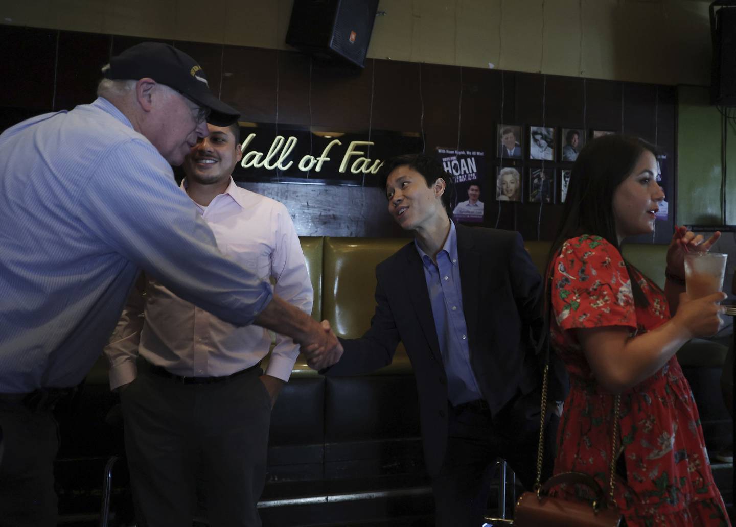 Hoan Huynh, Democratic candidate for Illinois House District 13, center, greets former Gov. Pat Quinn during a campaign event at the Holiday Club on Sept. 17, 2022, in Chicago. 