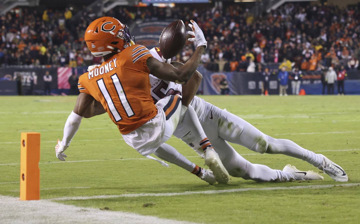 Bears wide receiver Darnell Mooney (11) reaches for the ball as Commanders cornerback Benjamin St-Juste defends at the goal line in the final seconds of the game Thursday at Soldier Field. Mooney was called short of the end zone, and the Bears lost 12-7. 