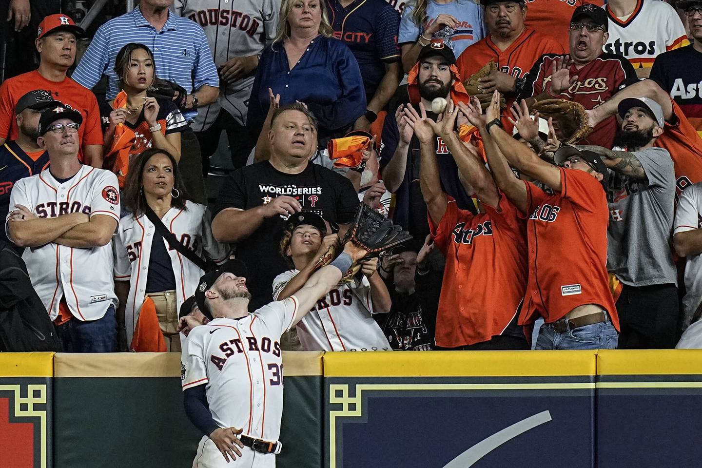 Astros right fielder Kyle Tucker leaps but can't get a glove on a home run by Phillies catcher J.T. Realmuto during the 10th inning in Game 1 of the World Series on Friday in Houston. 