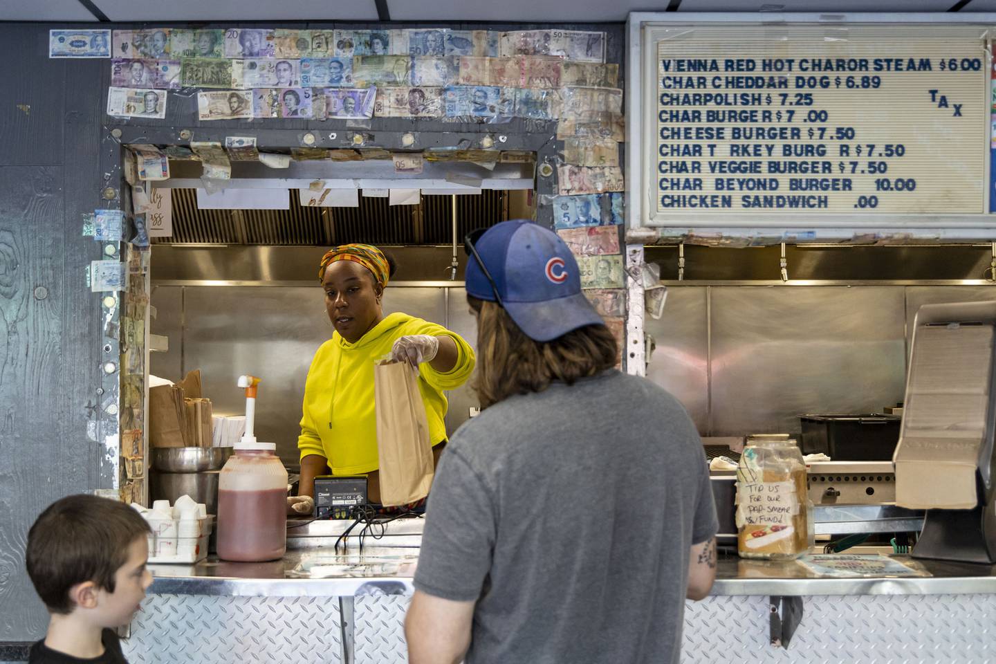 Toni Morris serves customers from behind the counter at The Wiener’s Circle on Oct. 5, 2022.  