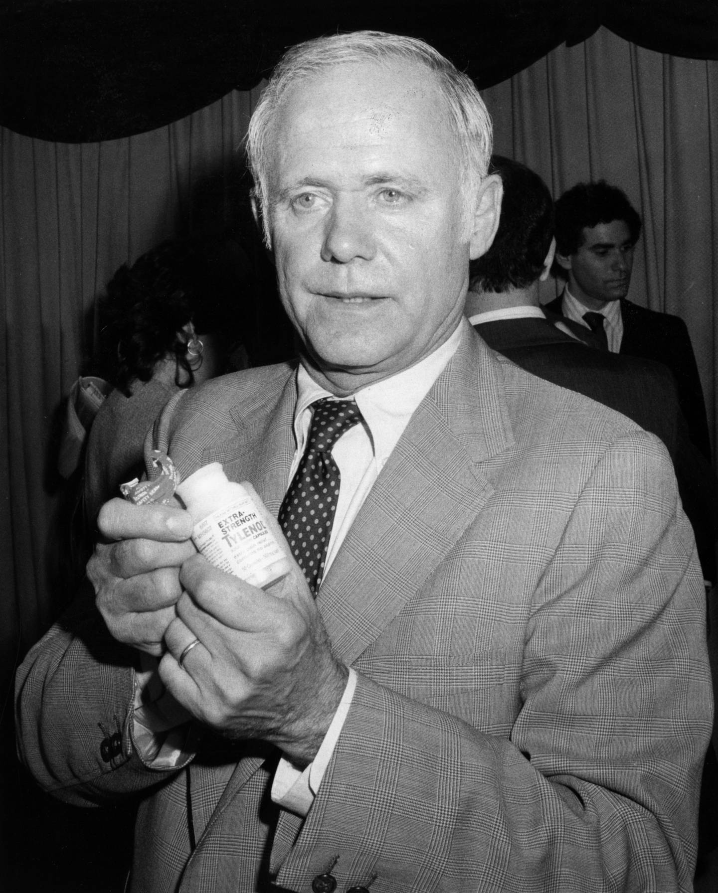 Johnson & Johnson CEO James Burke holds the tamper-resistant packaging developed for Tylenol in late 1982 in an attempt to save the brand.