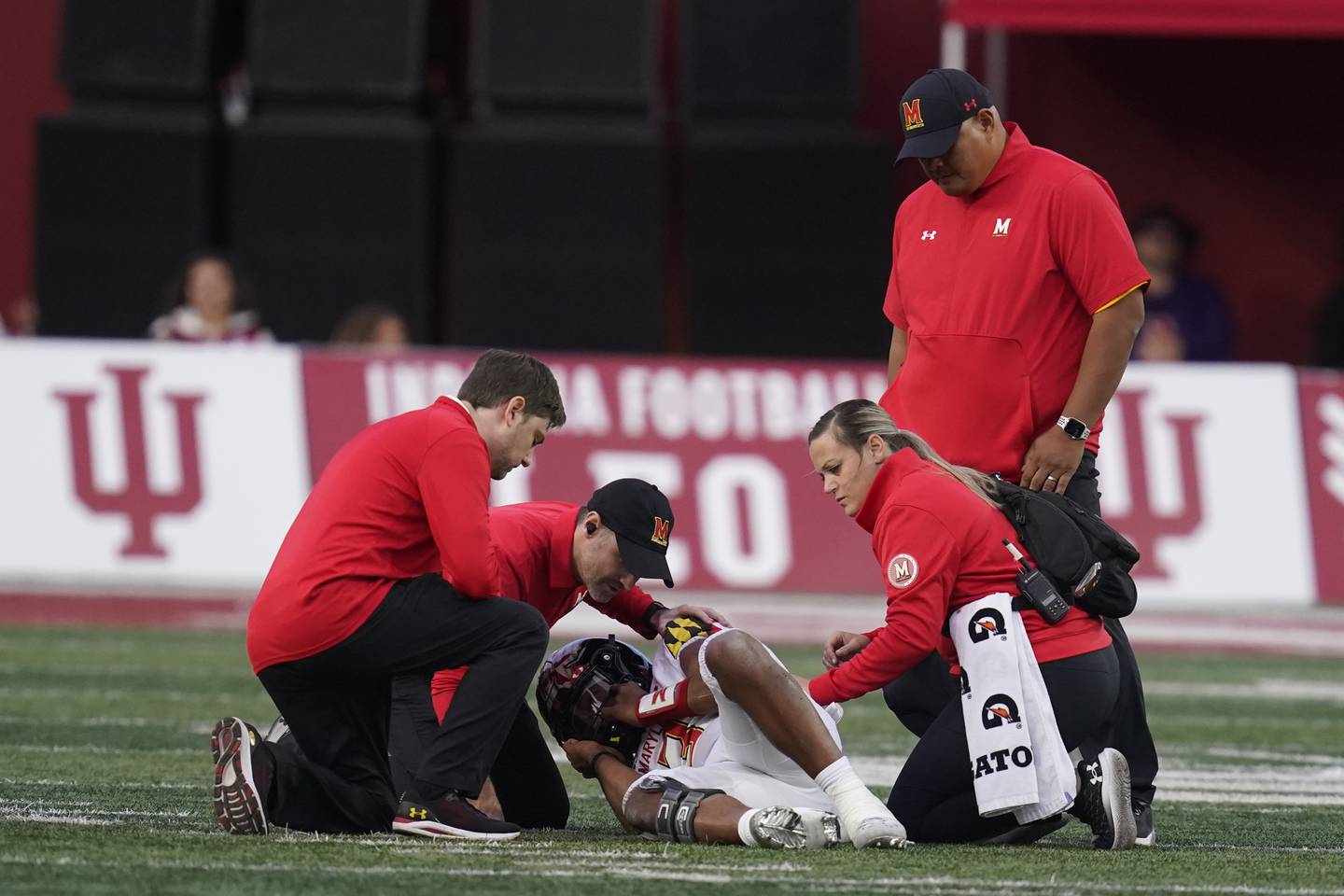 Taulia Tagovailoa, the Terps gunslinger being attended to by trainers in Bloomington against Indiana on Saturday, is considered a game-time decision against Northwestern this weekend after aggravating his sprained MCL.