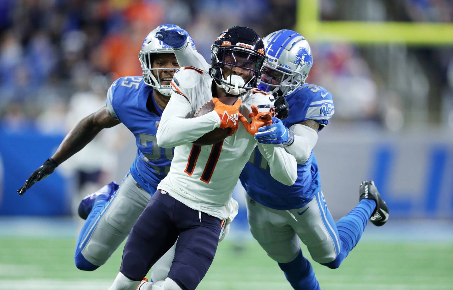 Bears wide receiver Darnell Mooney (11) makes a 52-yard reception as Lions safety Will Harris (25) and safety Dean Marlowe defend in the second quarter on Nov. 25, 2021, at Ford Field in Detroit.