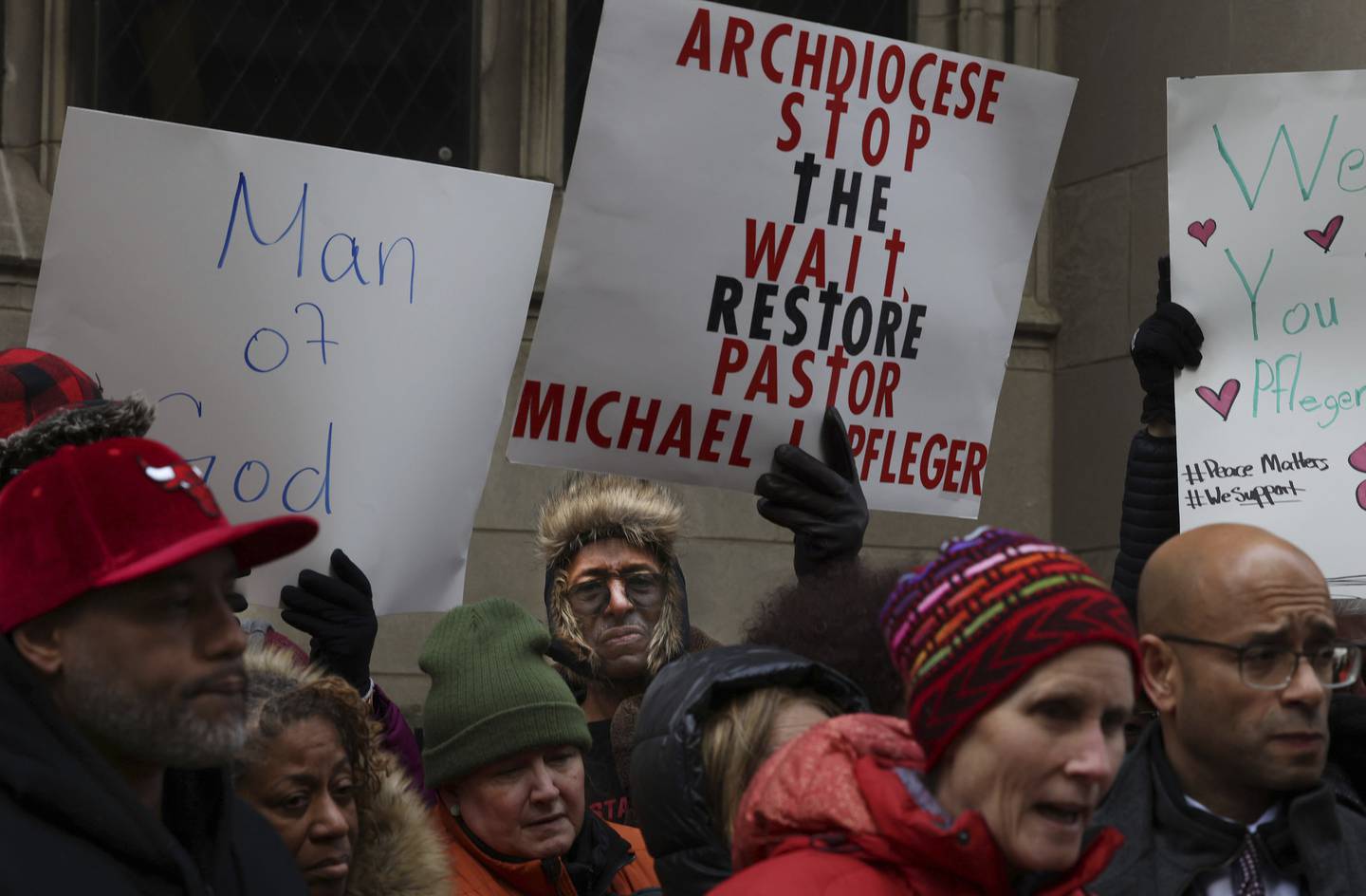 Community leaders and members of the St. Sabina parish rally in support of the Rev. Michael Pfleger outside the Archdiocese of Chicago on Nov. 17, 2022.