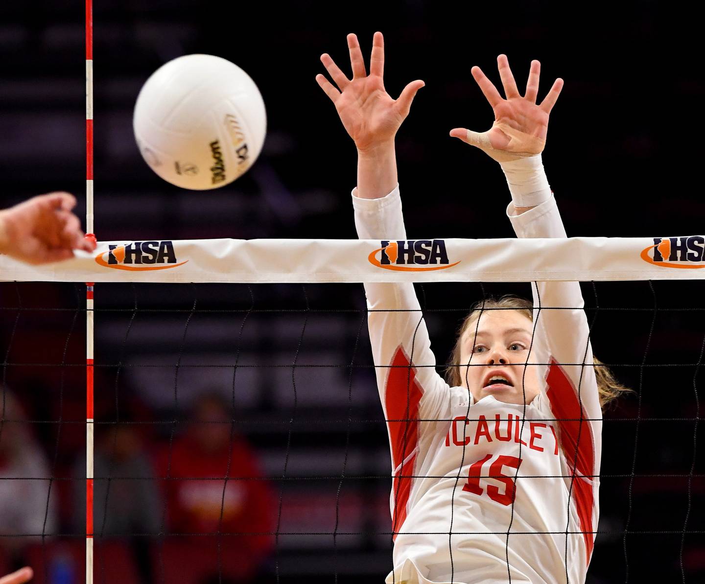 Mother McAuley's Mary Kate Sheehan (15) puts up a block against Benet during the Class 4A state championship match at Illinois State's Redbird Arena on Saturday, Nov. 12, 2022.