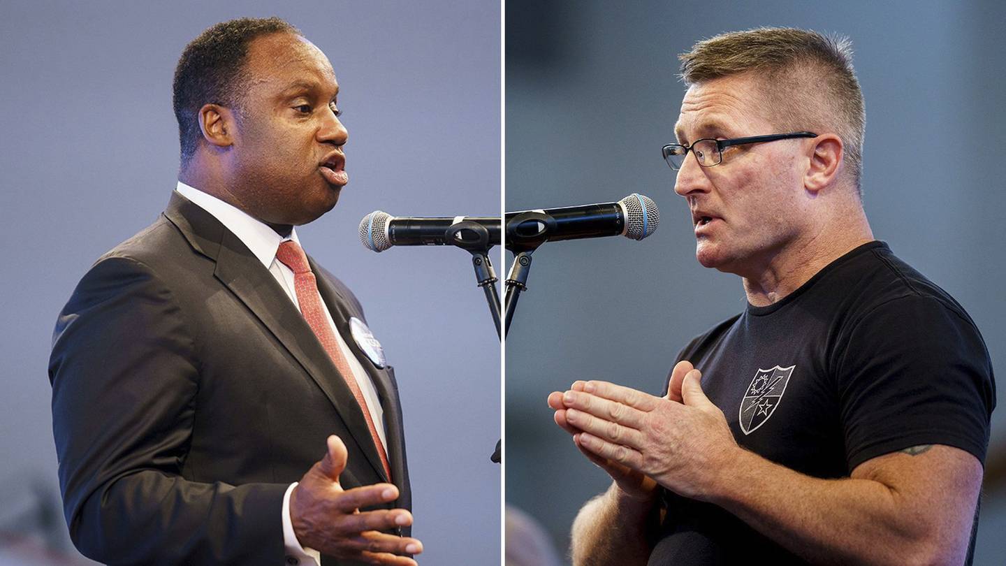Jonathan Jackson, left, Democratic candidate for the 1st Congressional District, and Republican candidate Eric Carlson appear at a forum at Freedom Temple Church in Chicago on May 10, 2022.