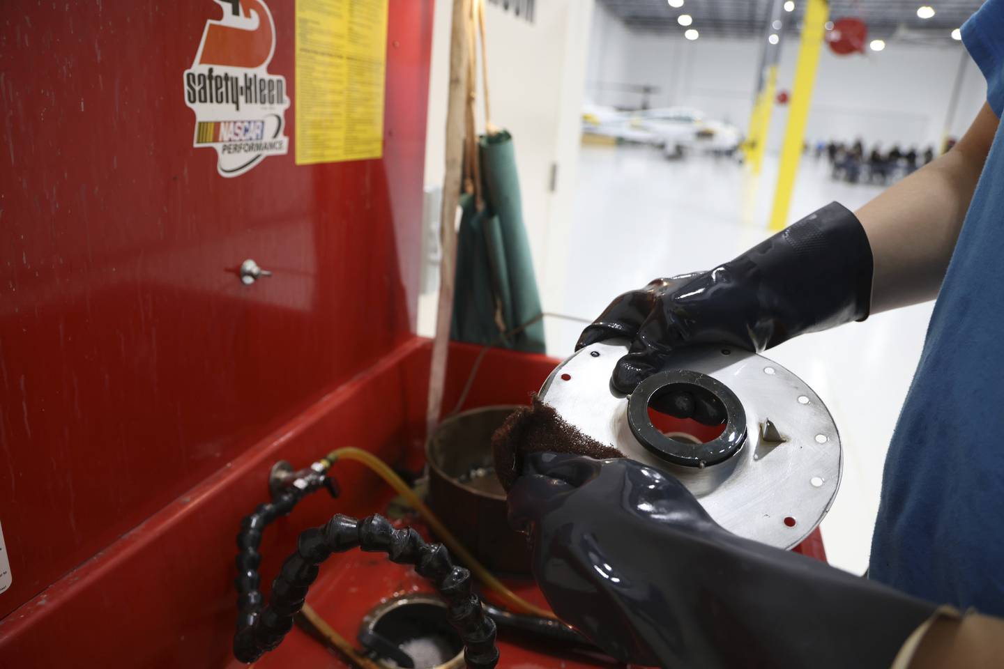 Sal Havelka washes aircraft parts at the Aviation Institute of Maintenance in Chicago.