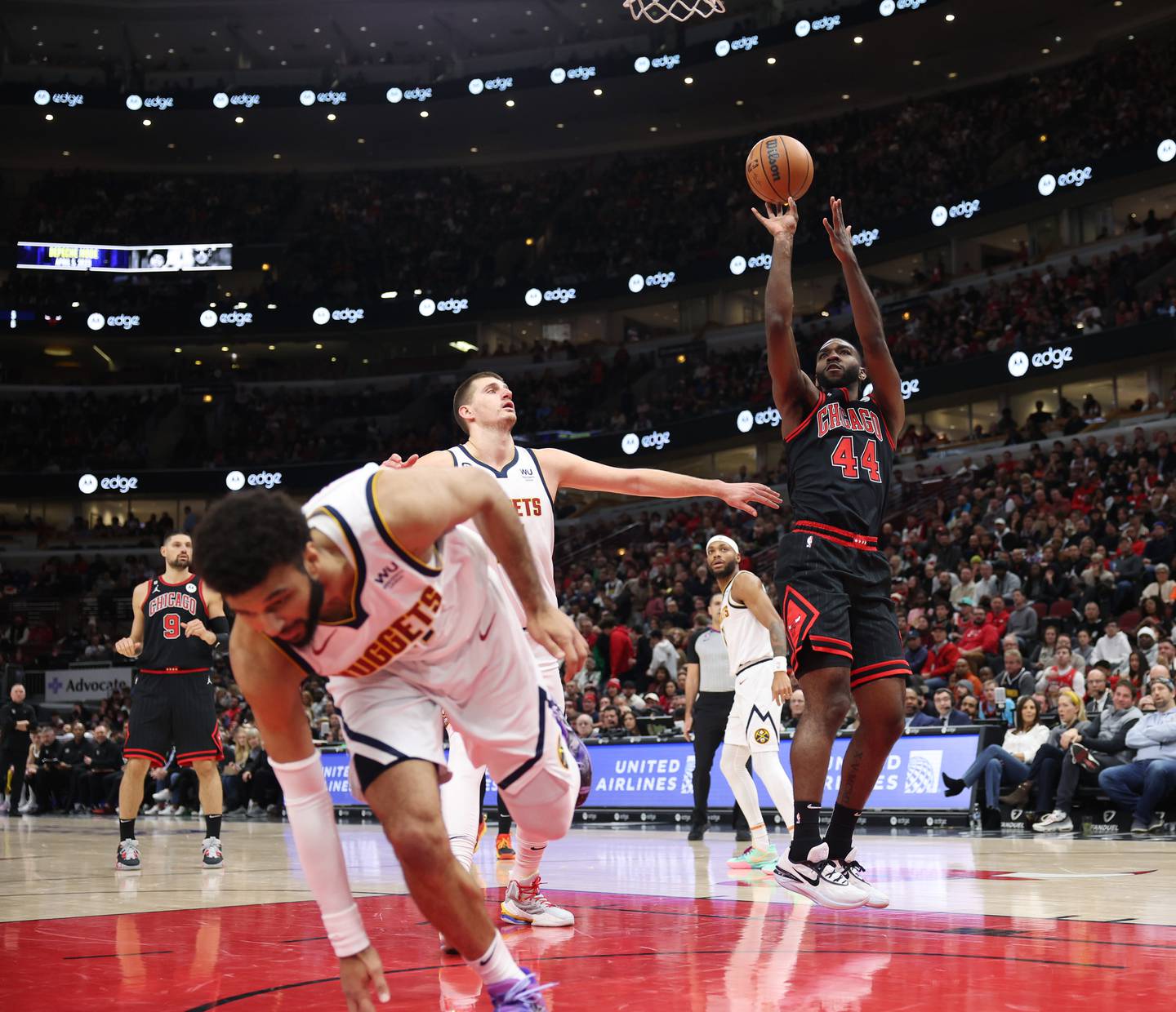 Chicago Bulls forward Patrick Williams (44) aims for a successful basket after being fouled by Denver Nuggets guard Jamal Murray (27), left, in the second quarter at United Center on Nov. 13, 2022, in Chicago.